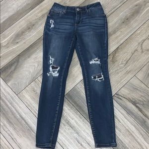 Dark blue jeans w/ cheetah patches under the holes